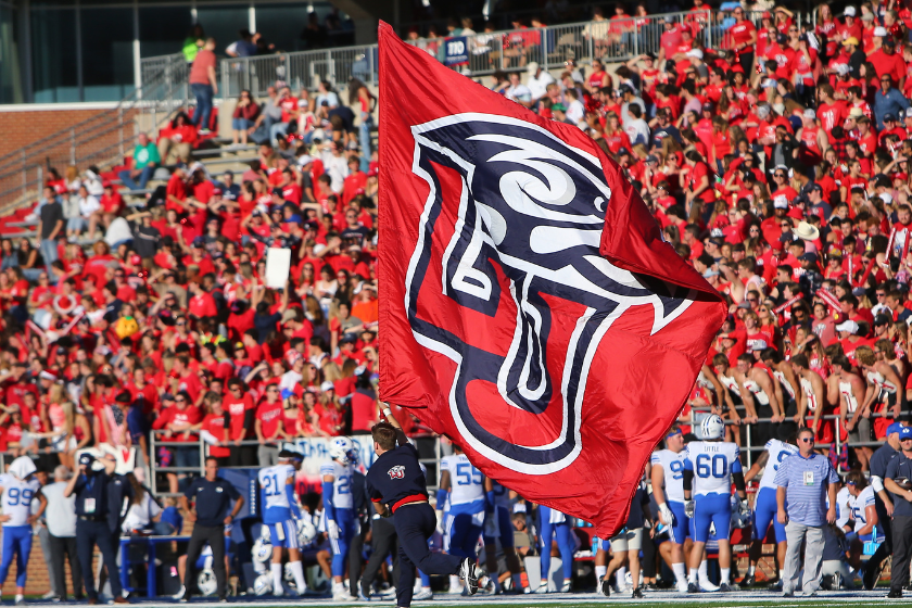 Liberty Flames cheerleader with flag during a college football game between the BYU Cougars and the Liberty Flames