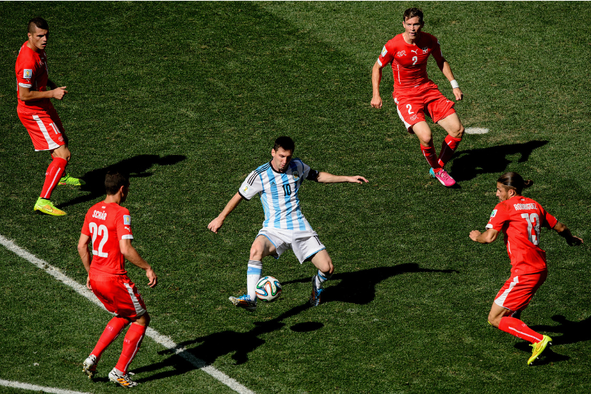 Lionel Messi of Argentina controls the ball against Josip Drmic (L), Fabian Schar (2nd L), Stephan Lichtsteiner (2nd R) and Ricardo Rodriguez of Switzerland during the 2014 FIFA World Cup Brazil