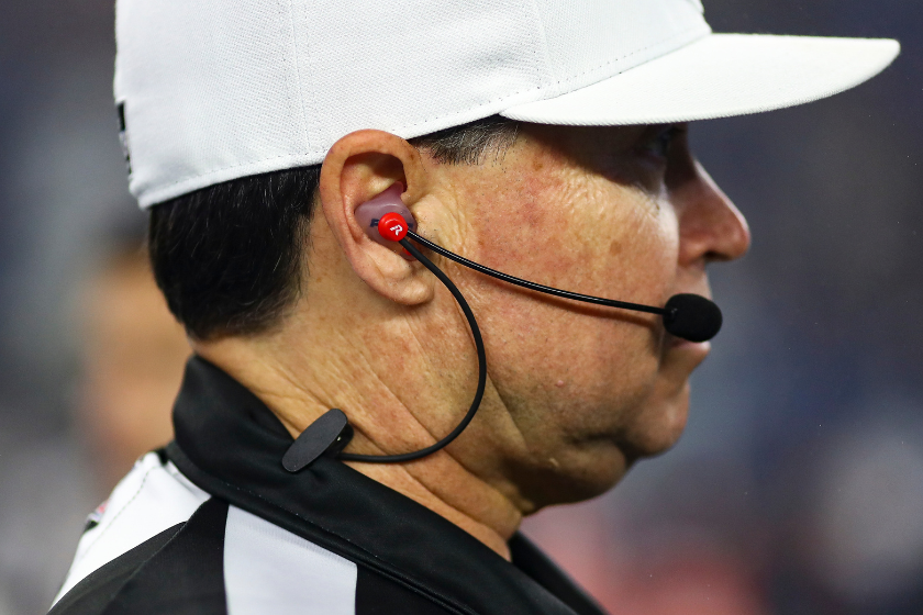 Referee Brad Allen #122 wears a communication radio and microphone prior to an NFL football game between the New England Patriots and the Chicago Bears 