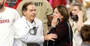 Nick Saban and Terry Saban embrace during a game.