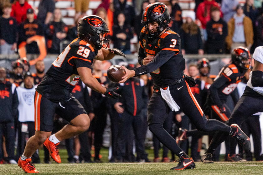uarterback Tristan Gebbia #3 of the Oregon State Beavers hands off the ball to running back Kanoa Shannon #29 during the second half of the game against the Colorado Buffaloes at Reser Stadium