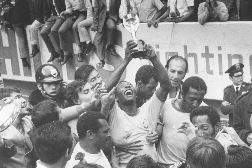 Pele, surrounded by teammates, is raising the Jues Rimet Trophy after beating Italy in the final - June 1970 