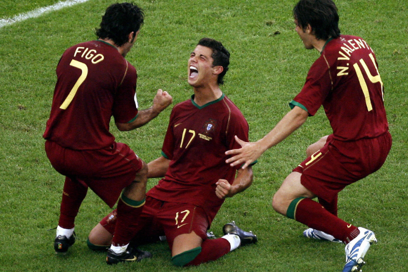 Portuguese forward Cristiano Ronaldo (C) celebrates his goal against Iran with teammates Luis Figo (L) and Nuno Valente during the World Cup 2006 group D football game Portugual vs.Iran