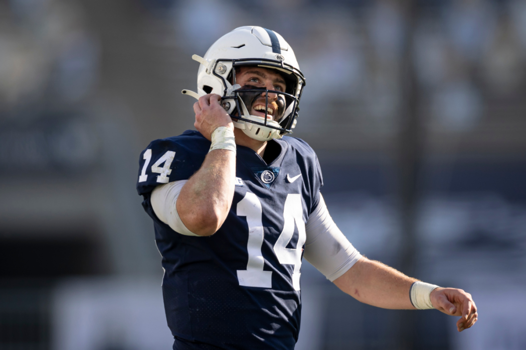 Sean Clifford #14 of the Penn State Nittany Lions reacts after scoring a touchdown against the Michigan State Spartans during the first half at Beaver Stadium