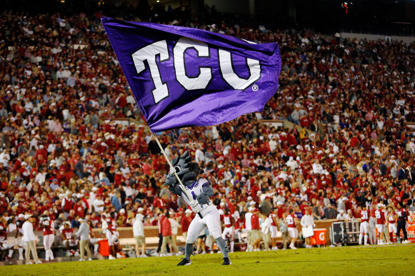 The Texas Christian University Horned Frogs mascot waves the TCU flag after a touchdown against the Oklahoma Sooners in the first quarter at Gaylord Family Oklahoma Memorial Stadium