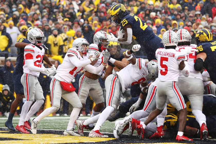 Hassan Haskins jumps for a touchdown against Ohio State.