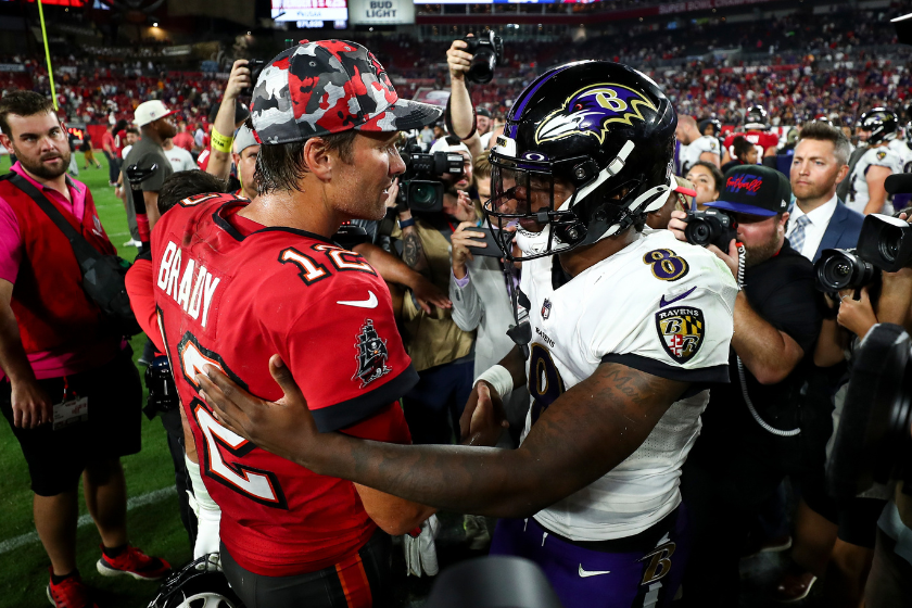 Tom Brady #12 of the Tampa Bay Buccaneers talks with Lamar Jackson #8 of the Baltimore Ravens after an NFL football game at Raymond James Stadium