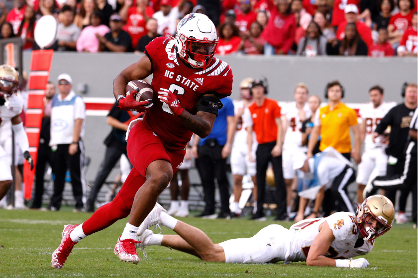  Trent Pennix #6 of the North Carolina State Wolfpack runs after a pass reception for a 27-yard touchdown during the first half against the Boston College Eagles