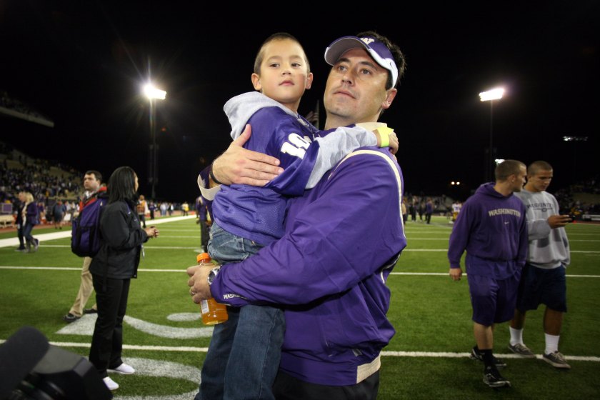 Steve Sarkisian holds his son Brady.