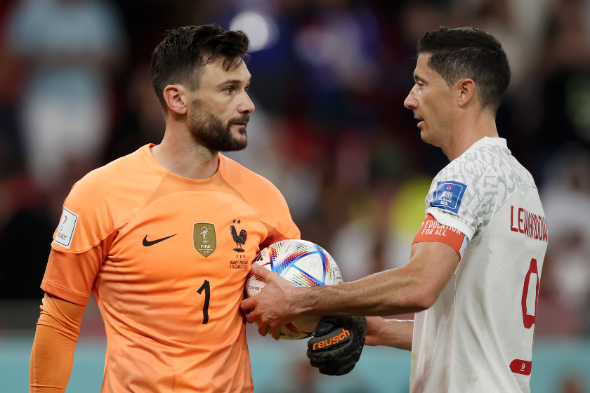 Robert Lewandowski of Poland takes the ball from Hugo Lloris of France before taking a penalty during the FIFA World Cup Qatar 2022 Round of 16 match between France and Poland at Al Thumama Stadium