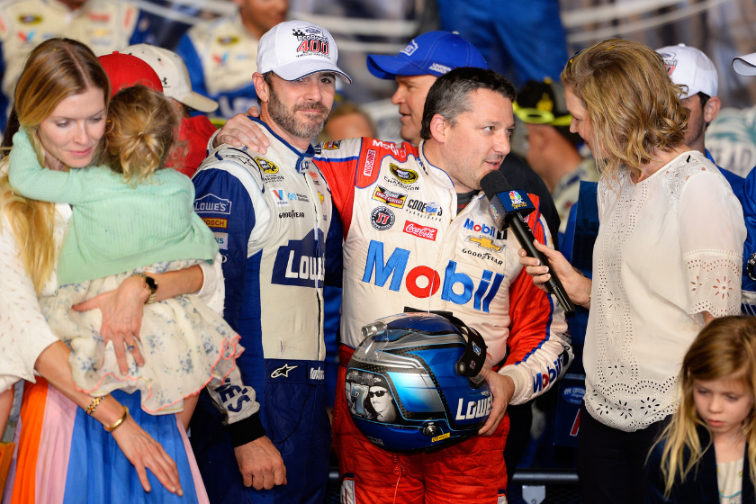 Jimmie Johnson celebrates with Tony Stewart in Victory Lane after winning the 2016 NASCAR Sprint Cup Series Championship at Homestead-Miami Speedway on November 20, 2016