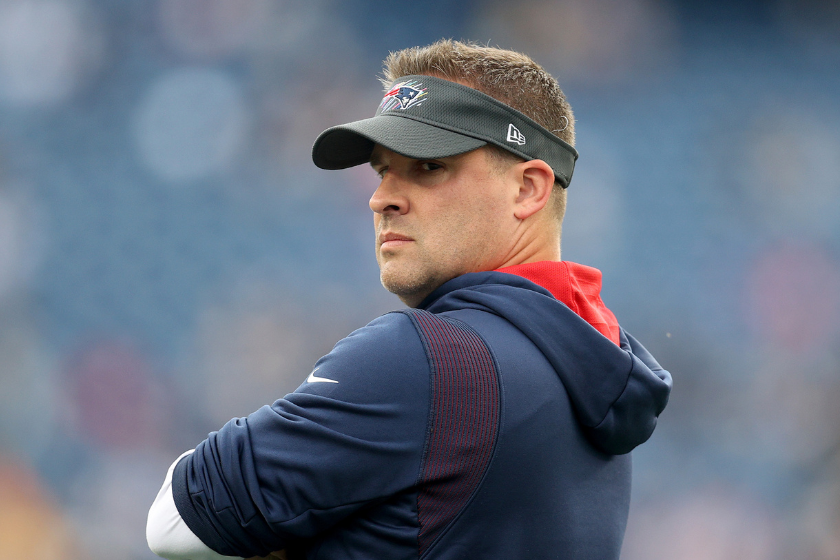 New England Patriots offensive coordinator Josh McDaniels stands on the field before their game against the Dallas Cowboys