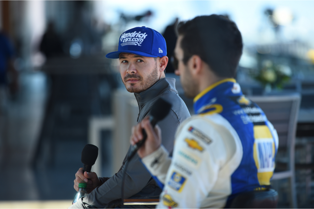Kyle Larson looks at Chase Elliott as he answers a question for a media press conference during the 2022 Busch Light Clash at The Coliseum