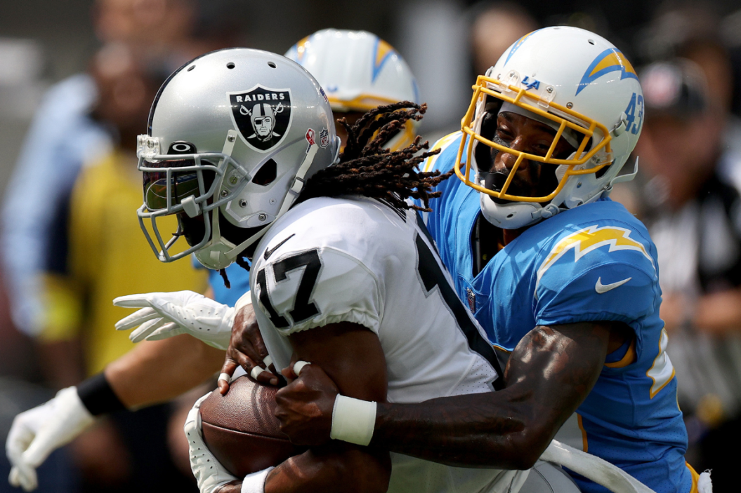 Davante Adams #17 of the Las Vegas Raiders is tackled by Michael Davis #43 of the Los Angeles Chargers during a 24-19 Los Angeles Chargers win