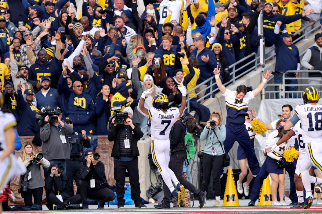 Michigan Wolverines running back Donovan Edwards (7) celebrates in front of the Michigan fans section after scoring on a 75-yard touchdown run during the fourth quarter of the college football game between the Michigan Wolverines and Ohio State Buckeye