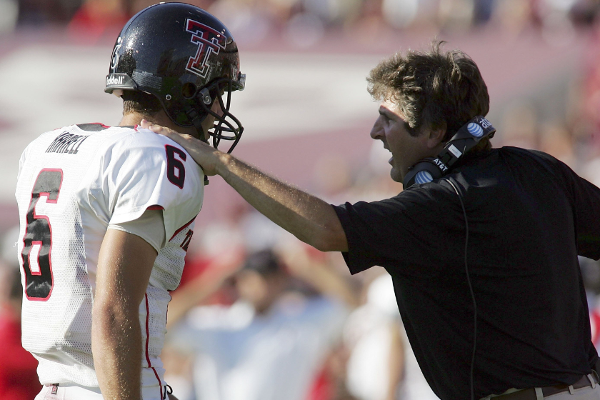 Quarterback Graham Harrell #6 of the Texas Tech Red Raiders talks with head coach Mike Leach during play against the Texas A&M Aggies