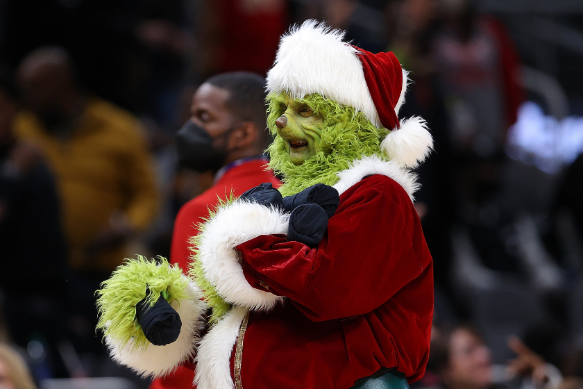 The Grinch character is seen throwing out shirts during the first half between the Atlanta Hawks and the Orlando Magic at State Farm Arena
