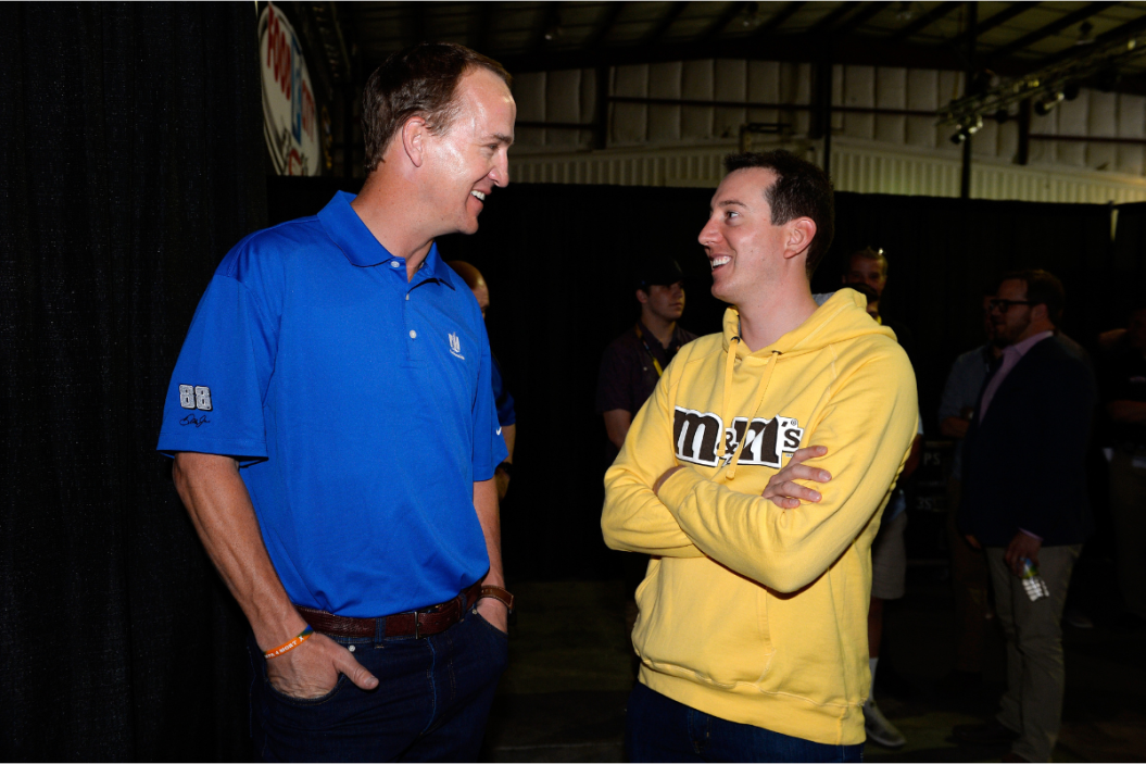 Peyton Manning talks with Kyle Busch prior to the 2016 Food City 500 at Bristol Motor Speedway