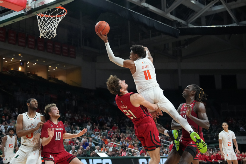 A Rutgers player attempts to take a charge from a Miami player.