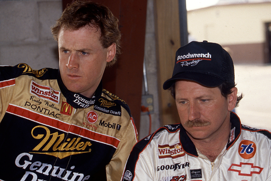 rusty wallace and dale earnhardt confer at a cup race in 1990