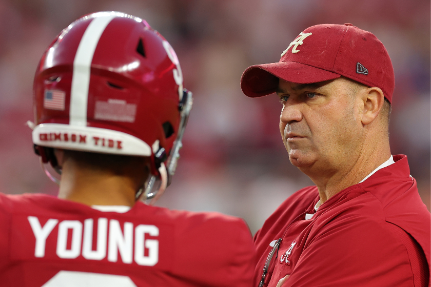 Offensive coordinator Bill O'Brien converses with Bryce Young #9 of the Alabama Crimson Tide during pregame warmups prior to facing the Texas A&M Aggies at Bryant-Denny Stadium