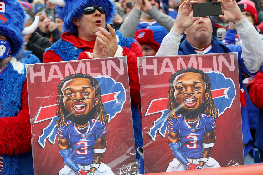 Buffalo Bills fans hold signs in support of Buffalo Bills safety Damar Hamlin during a game against the New England Patriots at Highmark Stadium