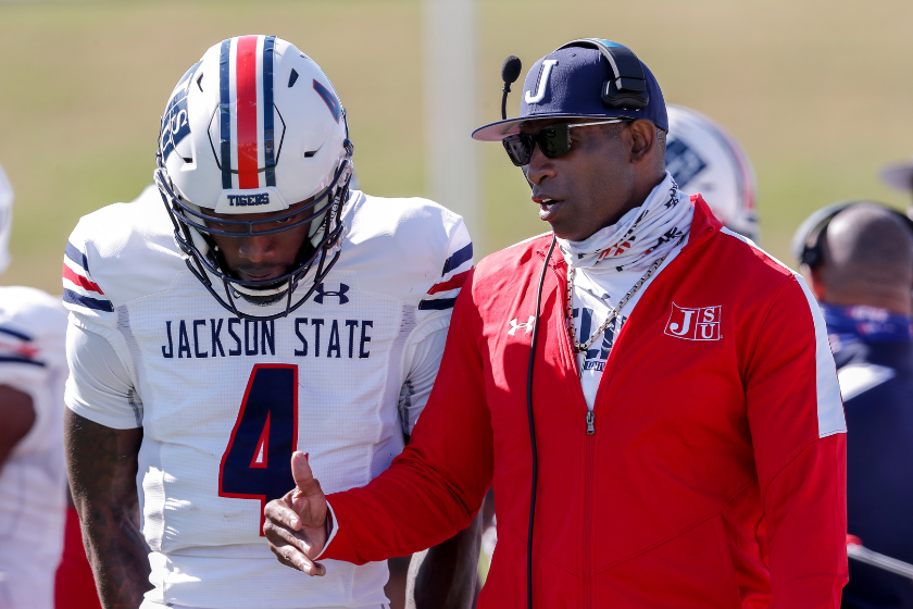 Head Coach Deion Sanders talk with his quarterback Jalon Jones #4 of the Jackson State Tigers during a time out during the game against the Alabama State Hornets at New ASU Stadium 