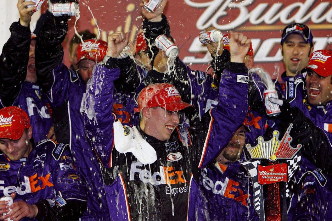 Denny Hamlin celebrates in victory lane after winning the 2006 Budweiser Shootout at Daytona International Speedway
