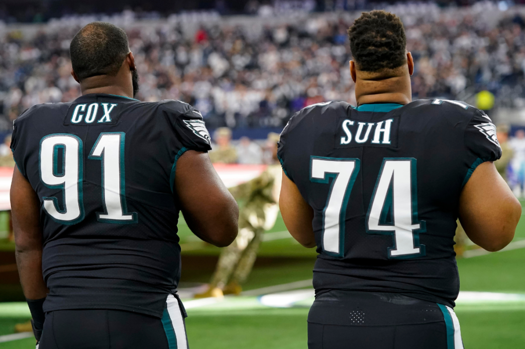 Fletcher Cox #91 and Ndamukong Suh #74 of the Philadelphia Eagles stand on the field during the playing of the national anthem before a game against the Dallas Cowboys