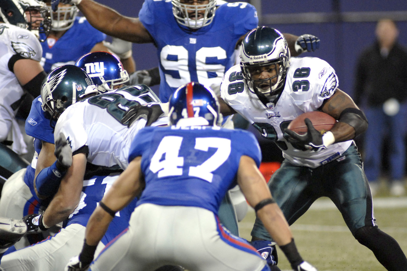 Philadelphia Eagles running back Brian Westbrook trying to break away from New York Giants # 47 safety Will Demps during the Philadelphia Eagles vs New York Giants game