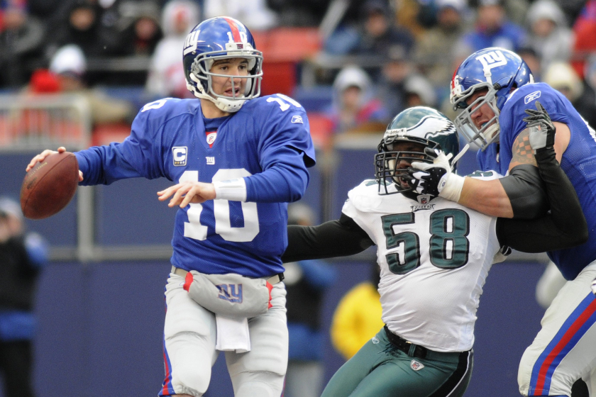 Quarterback Eli Manning #10 of the New York Giants passes during a NFL game against the Philadelphia Eagles at Giants Stadium