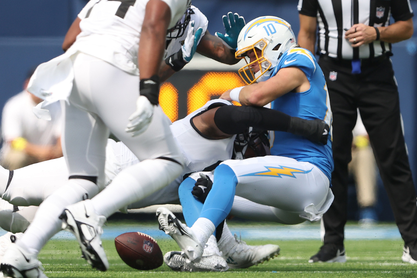 ustin Herbert #10 of the Los Angeles Chargers fumbles the ball while being sacked by Dawuane Smoot #91 of the Jacksonville Jaguars during the second quarter at SoFi Stadium