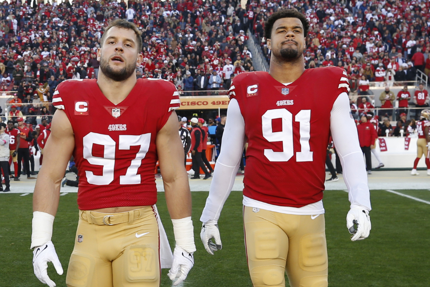 Nick Bosa #97 and Arik Armstead #91 of the San Francisco 49ers head to midfield for the coin toss before the NFC Divisional playoff game against the Dallas Cowboys at Levi's Stadium.