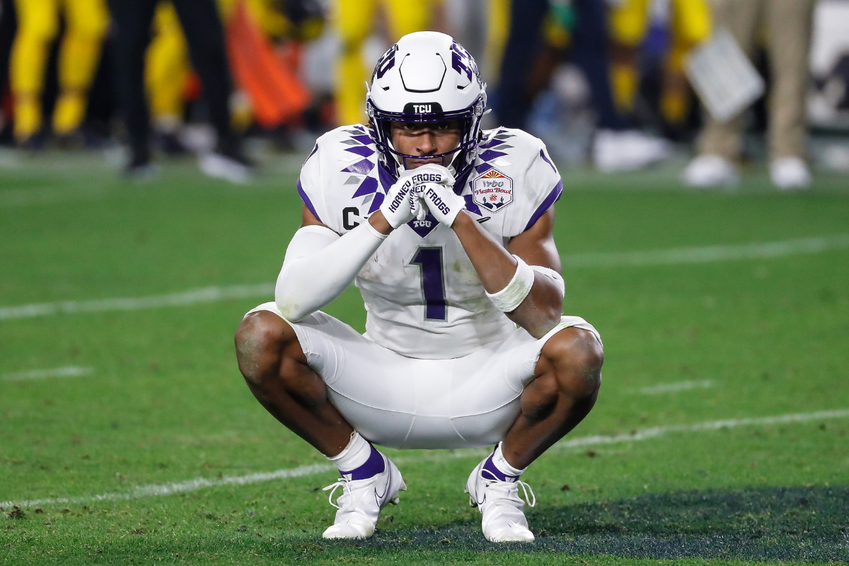 TCU Horned Frogs wide receiver Quentin Johnston (1) prays on the field while waiting for a replay review during the VRBO Fiesta Bowl college football national championship semifinal game between the Michigan Wolverines and the TCU Horned Frogs