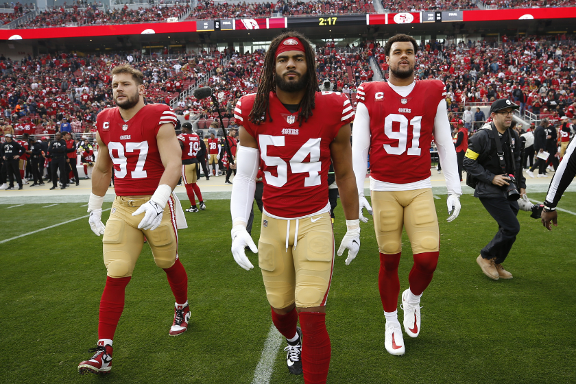 Nick Bosa #97, Fred Warner #54 and Arik Armstead #91 of the San Francisco 49ers head to midfield for the coin toss before the game against the Arizona Cardinals at Levi's Stadium