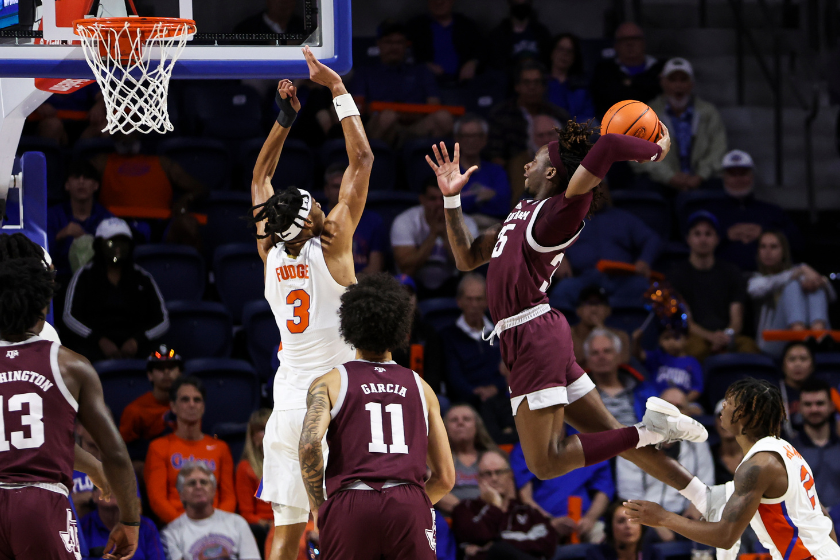 Manny Obaseki #35 of the Texas A&M Aggies dunks the ball against Alex Fudge #3 of the Florida Gators during the second half of a game.
