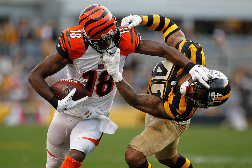 A.J. Green #18 of the Cincinnati Bengals attempts to shed Antwon Blake #41 of the Pittsburgh Steelers before both being called for face-mask penalties in the 4th quarter of the game at Heinz Field