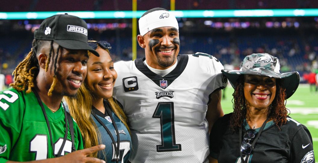 Jalen Hurts poses with family for a picture after an Eagles game.