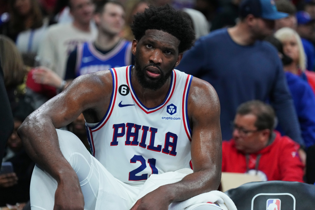 Joel Embiid #21 of the Philadelphia 76ers looks on from the bench against the Denver Nuggets at the Wells Fargo Center