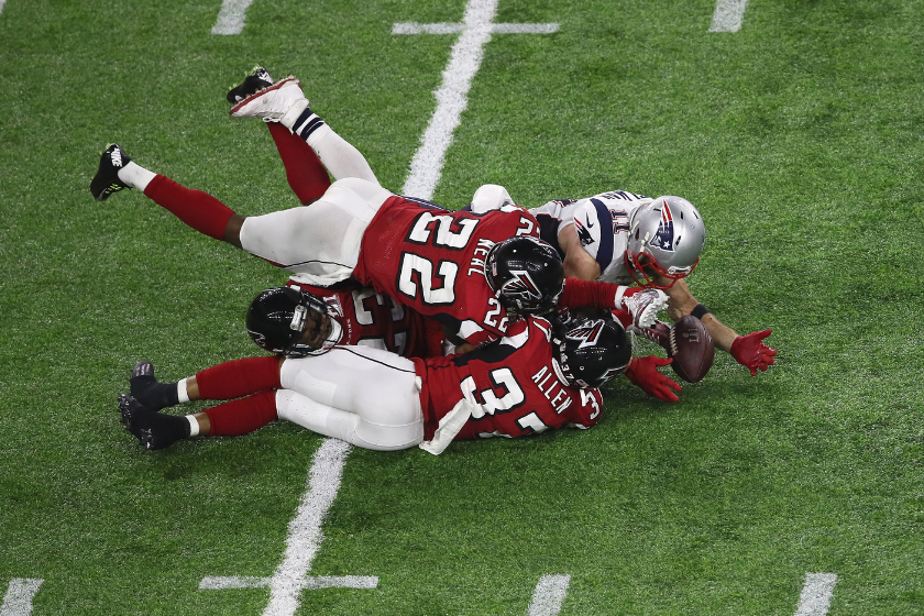 Julian Edelman #11 of the New England Patriots makes a 23 yard catch in the fourth quarter against Ricardo Allen #37, Robert Alford #23 and Keanu Neal #22 of the Atlanta Falcons during Super Bowl 51