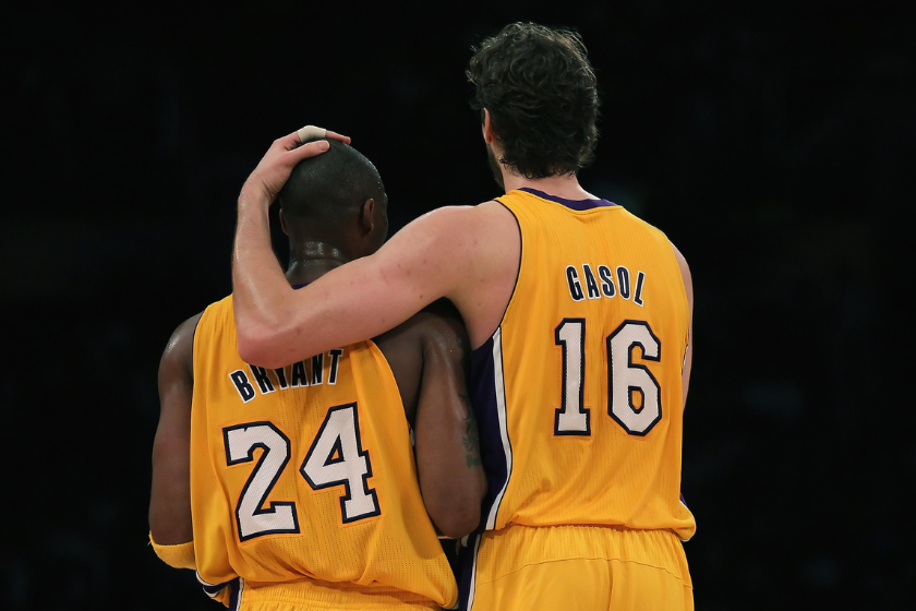 Pau Gasol #16 of the Los Angeles Lakers puts his arm around teammate Kobe Bryant #24 during the third quarter against the Memphis Grizzlies at Staples Center