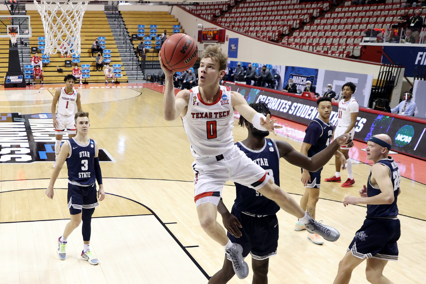 Mac McClung #0 of the Texas Tech Red Raiders drives to the basket during the first half against the Utah State Aggies in the first round game of the 2021 NCAA Men's Basketball Tournament 