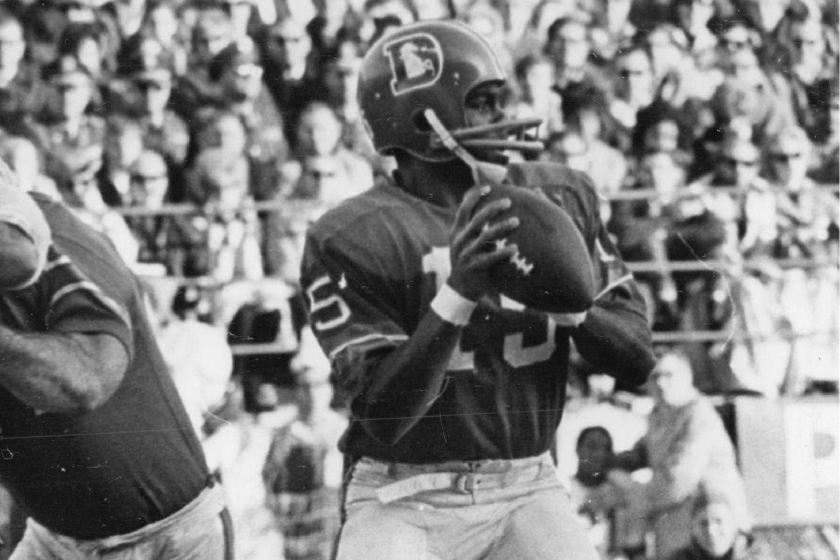 Denver quarterback Marlin Briscoe is unaware that a battle is occurring behind him in the first quarter Saturday. Denver's Sam Brunelli is shown holding Kansas City's Aaron Brown while Briscoe prepares to let loose with a pass
