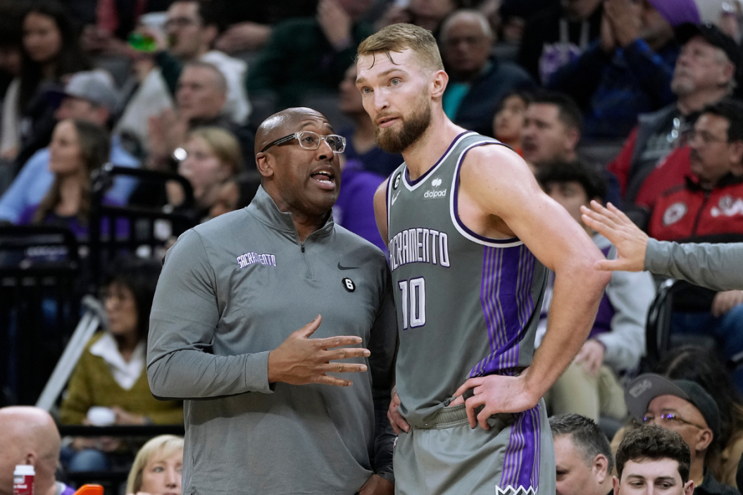 Head coach Mike Brown of the Sacramento Kings talks with his player Domantas Sabonis #10 against the Philadelphia 76ers during the third quarter of an NBA basketball game at Golden 1 Center