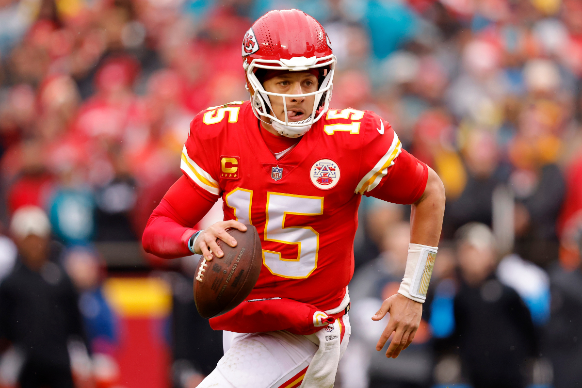 Patrick Mahomes #15 of the Kansas City Chiefs scrambles to throw a touchdown pass against the Jacksonville Jaguars during the first quarter in the AFC Divisional Playoff game at Arrowhead Stadium