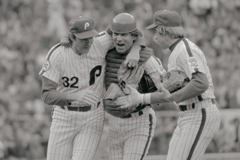 Phillies' pitcher Steve Carlton (L) gets a warm reception form his catcher, Tim McCarver, and first baseman, Tommy Hutton, after he won his 20th game at Vet Stadium