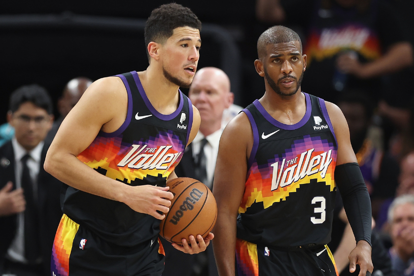 Devin Booker #1 and Chris Paul #3 of the Phoenix Suns react after defeating the Dallas Mavericks in Game One of the Western Conference Second Round NBA Playoffs