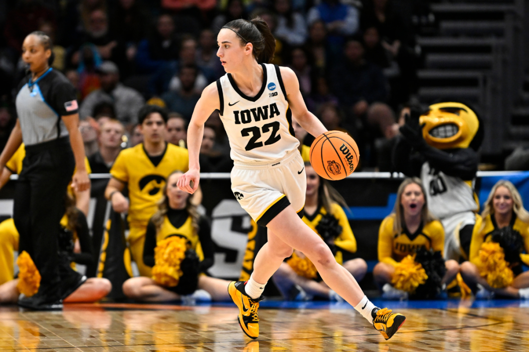 Caitlin Clark #22 of the Iowa Hawkeyes dribbles the ball against the Louisville Cardinals during the fourth quarter in the Elite Eight round of the NCAA Women's Basketball Tournament at Climate Pledge Arena