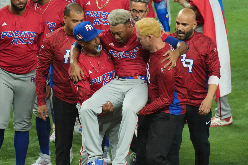 Edwin Diaz #39 of Puerto Rico is helped off the field after being injured during the on-field celebration after defeating the Dominican Republic during the World Baseball Classic Pool D at loanDepot park