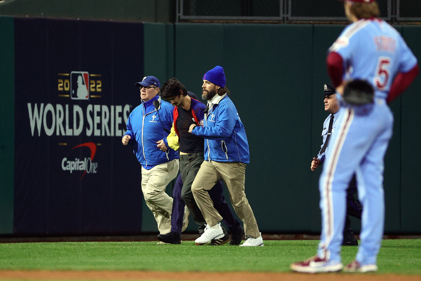 A fan is removed from the field by security during the sixth inning between the Houston Astros and Philadelphia Phillies in Game Five of the 2022 World Series at Citizens Bank Park 
